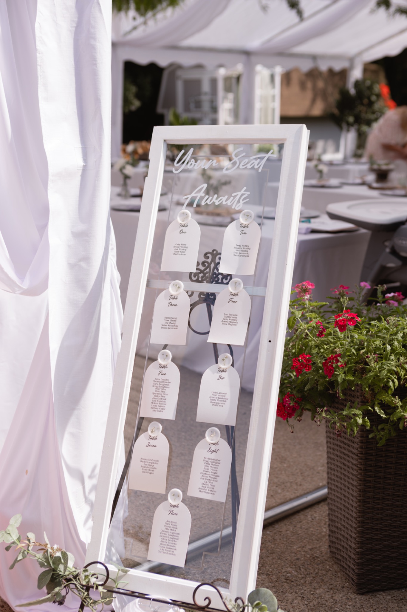 Custom white seating chart sign at an outdoor event